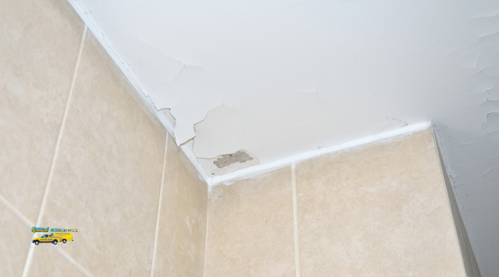 Cracks forming along the corner seam where the ceiling meets the wall, showing signs of structural stress in a home interior.