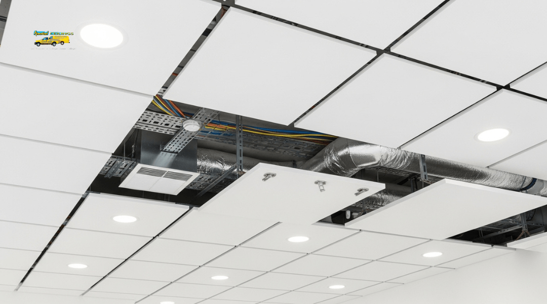 Acoustic ceiling panels concealing wiring, ductwork, and imperfections for a clean modern interior.